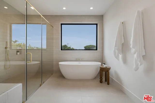 a bathroom with a double vanity sink mirror and shower