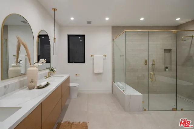 a bedroom with a large bed and a large window