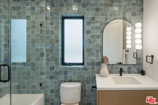 a bedroom with two beds and a window