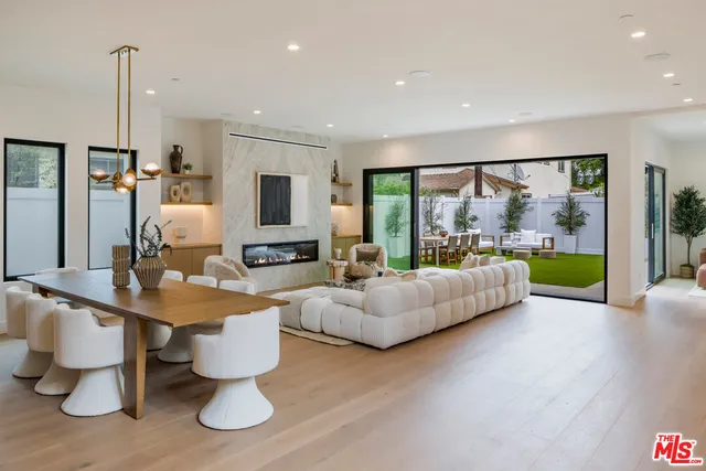 a living room with furniture and a large mirror