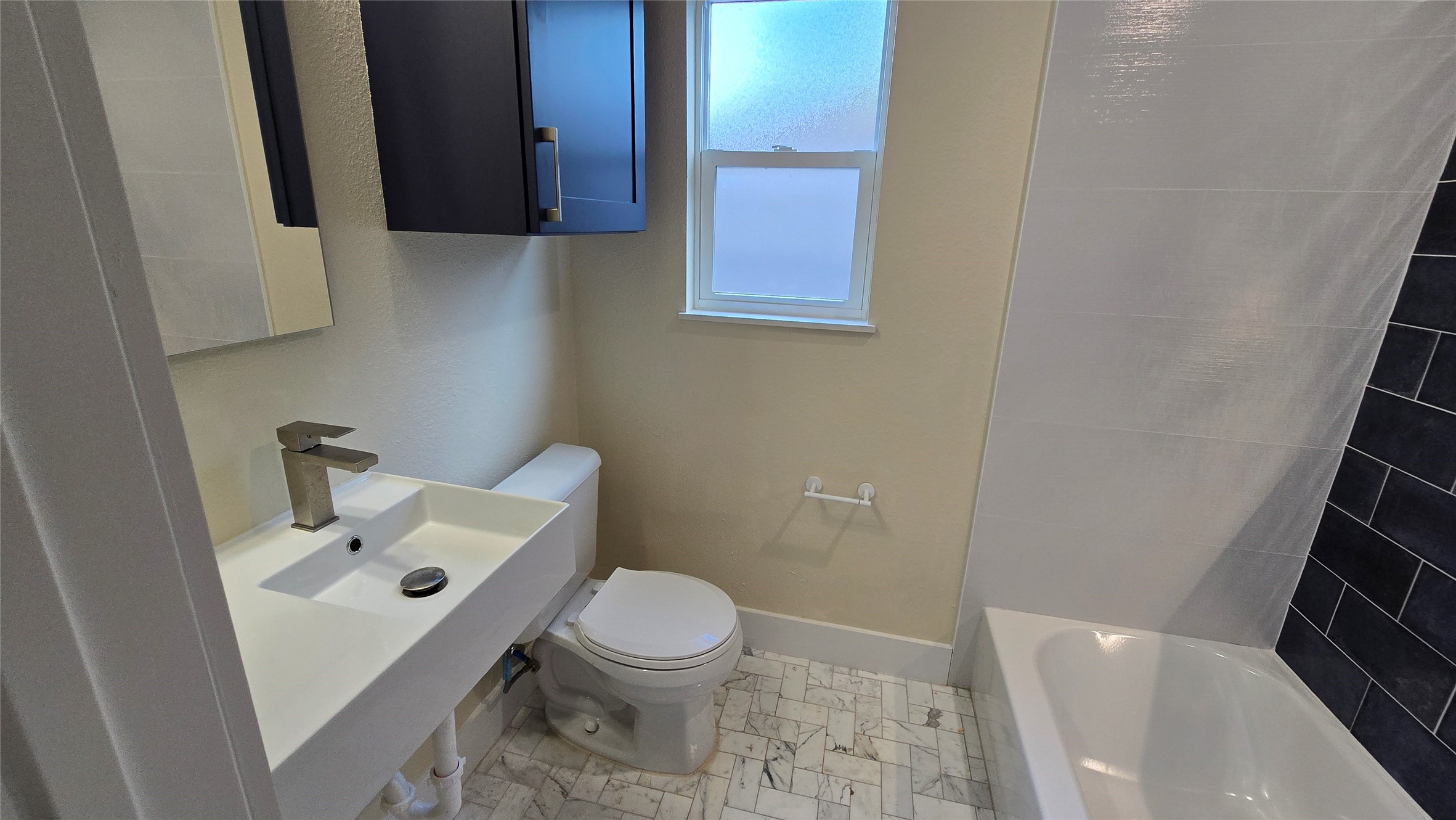 3741 Seabrook Street Houston, TX 77021 - Photo 36 of 50 a white toilet sitting next to a bathroom sink