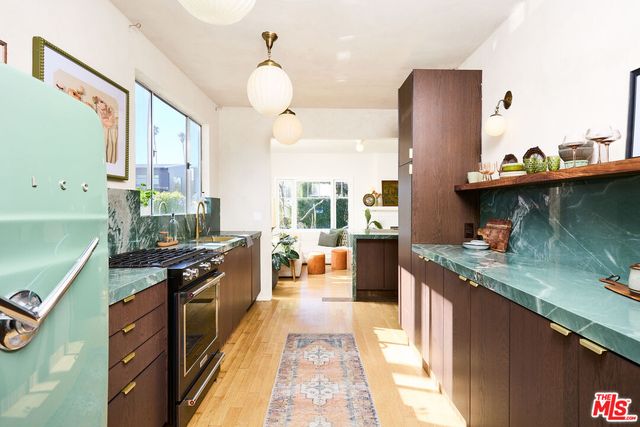 a kitchen with stainless steel appliances granite countertop a stove and a sink