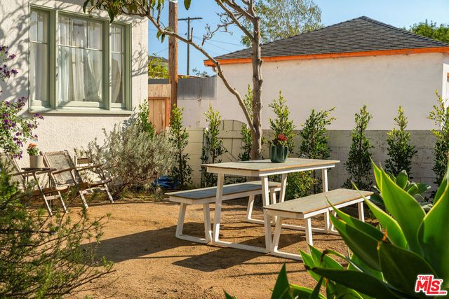 a wooden bench sitting in front of a building