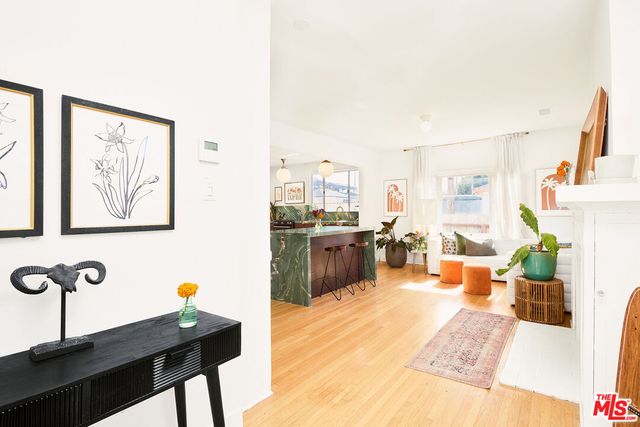 a living room with furniture a rug and a painting