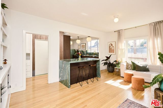 a living room with kitchen island furniture and a wooden floor
