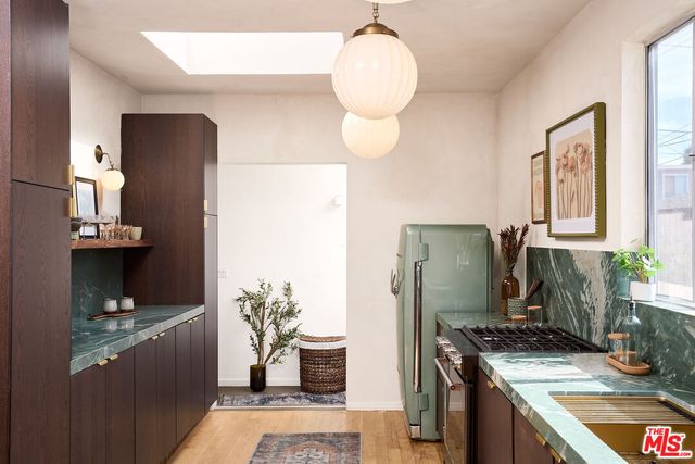 a bedroom with a bed wooden floor and window