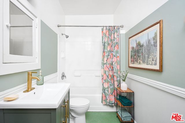 a living room with couches a flat screen tv and a couch