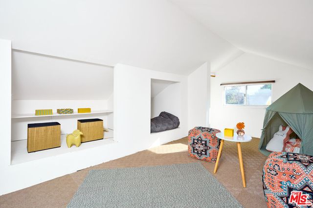 a view of backyard with outdoor seating and plants