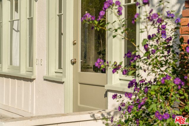 a front view of a house with flowers