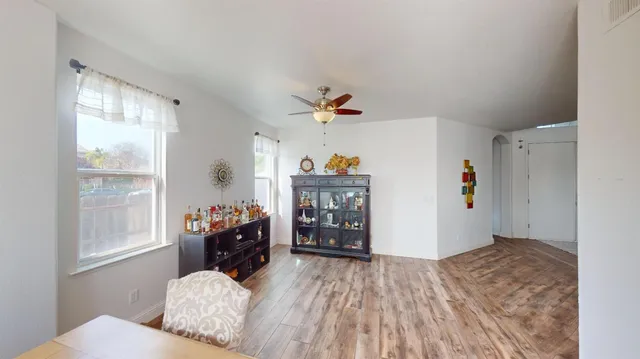 a living room with furniture and wooden floor
