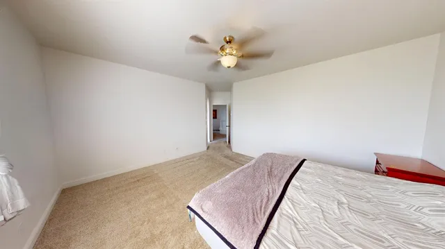 a large white bathroom with a large tub sink and mirror