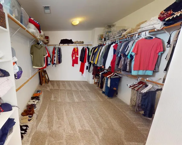 a room with a bed and a chandelier