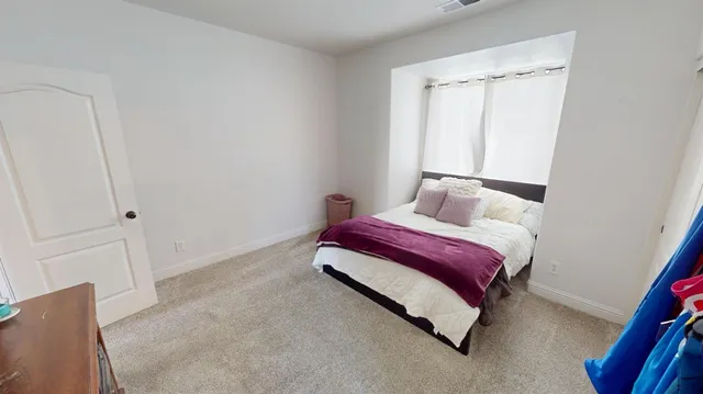 a bedroom with a bed and a window