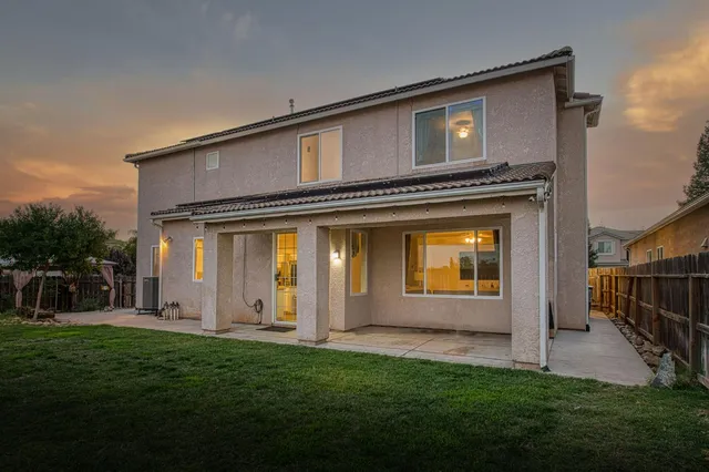 a front view of house with outdoor seating and yard