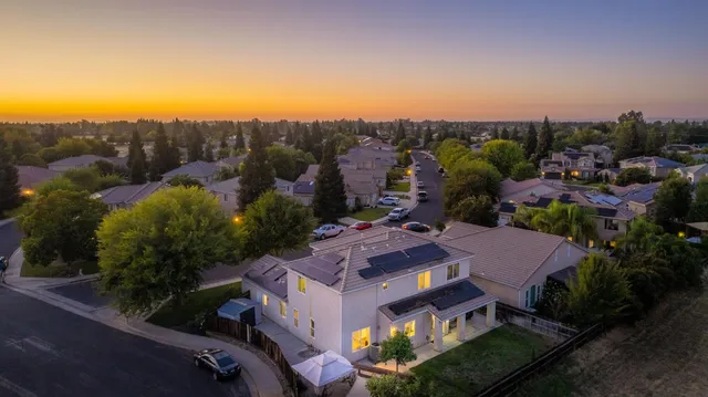 an aerial view of multiple houses with yard