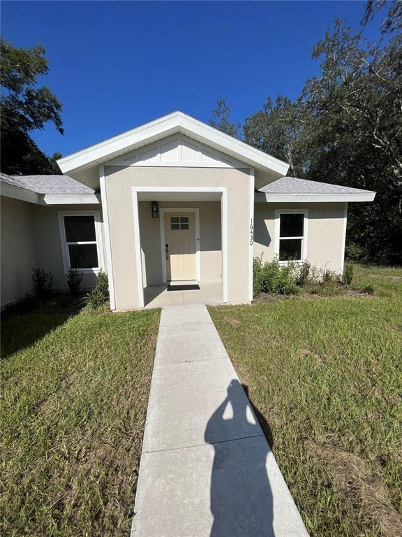 16430 Southeast 89th Court Summerfield, FL 34491 - Photo 1 of 69 a front view of a house with a yard