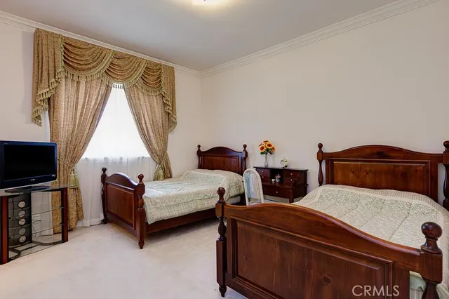 a bedroom with furniture and a flat screen tv