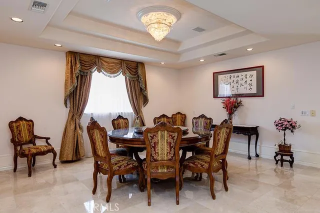 a view of a dining room with furniture and a chandelier