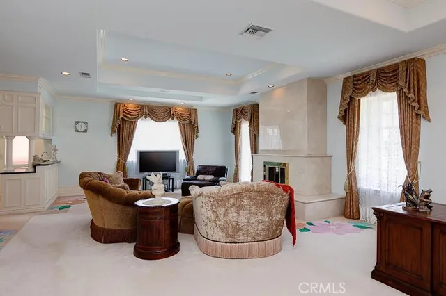 a living room with fireplace furniture and a large window