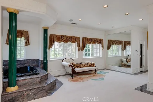 a living room with furniture and a floor to ceiling window