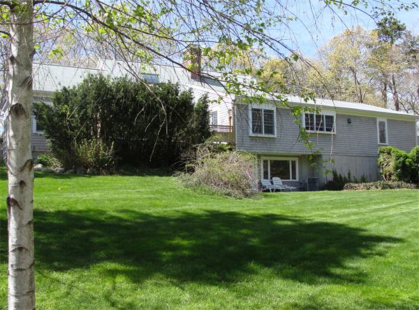 578 Huckins Neck Road Barnstable, MA 02632 - Photo 2 of 13 a view of a big yard in front of a house with a large tree
