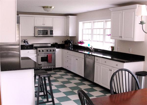 578 Huckins Neck Road Barnstable, MA 02632 - Photo 3 of 13 a kitchen with stainless steel appliances a stove a sink a microwave and cabinets
