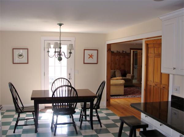 578 Huckins Neck Road Barnstable, MA 02632 - Photo 4 of 13 a view of a dining room with furniture a chandelier and wooden floor