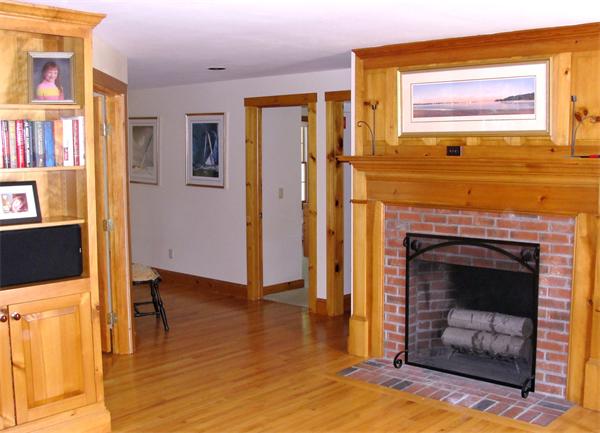 578 Huckins Neck Road Barnstable, MA 02632 - Photo 6 of 13 a living room with a fireplace furniture and a ceiling fan