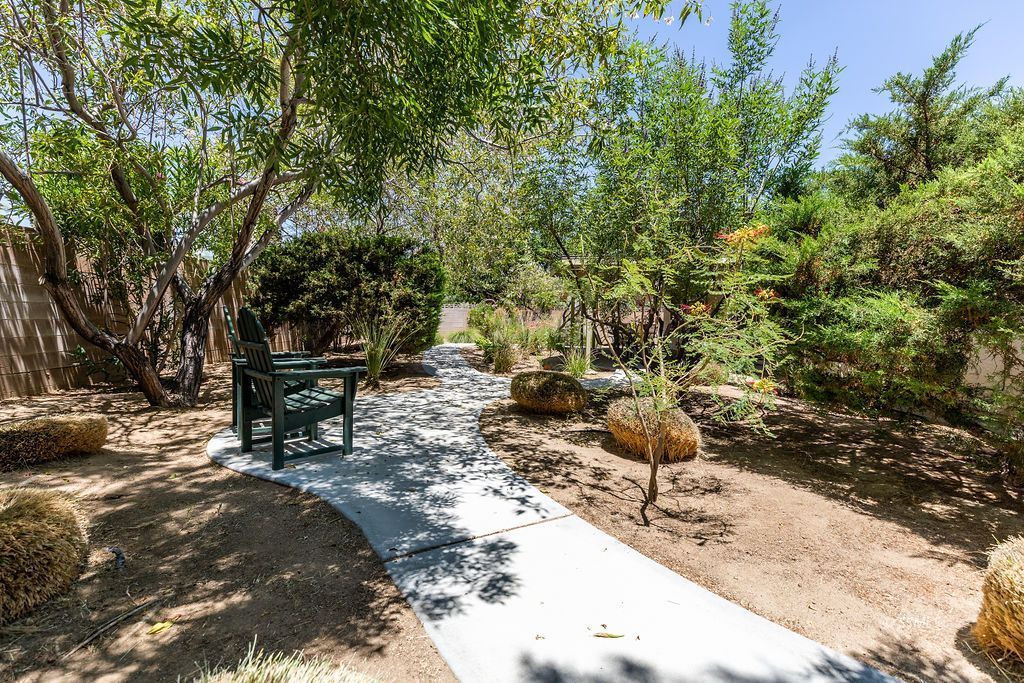 831 Peg Street Ridgecrest, CA 93555 - Photo 30 of 32 a view of a backyard with chairs and a tree