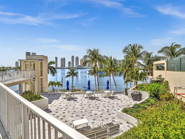 a view of balcony with two chairs and a potted plant