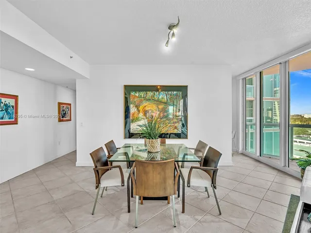 a view of a dining room with furniture and a potted plant