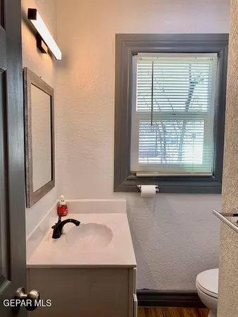 a bathroom with a sink toilet and mirror