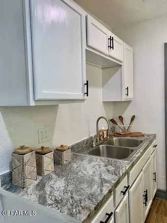 a kitchen with a sink cabinets and utility