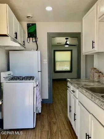 a kitchen with a stove a refrigerator and a sink