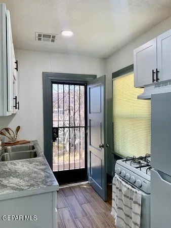 a room with a balcony a bed furniture and a window