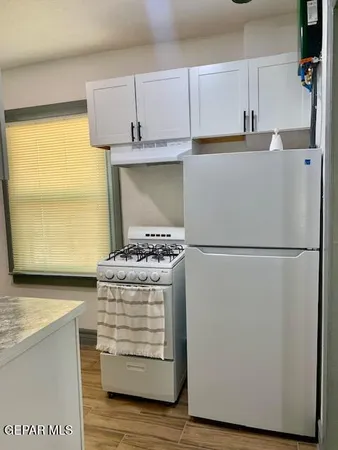a kitchen with appliances and cabinets