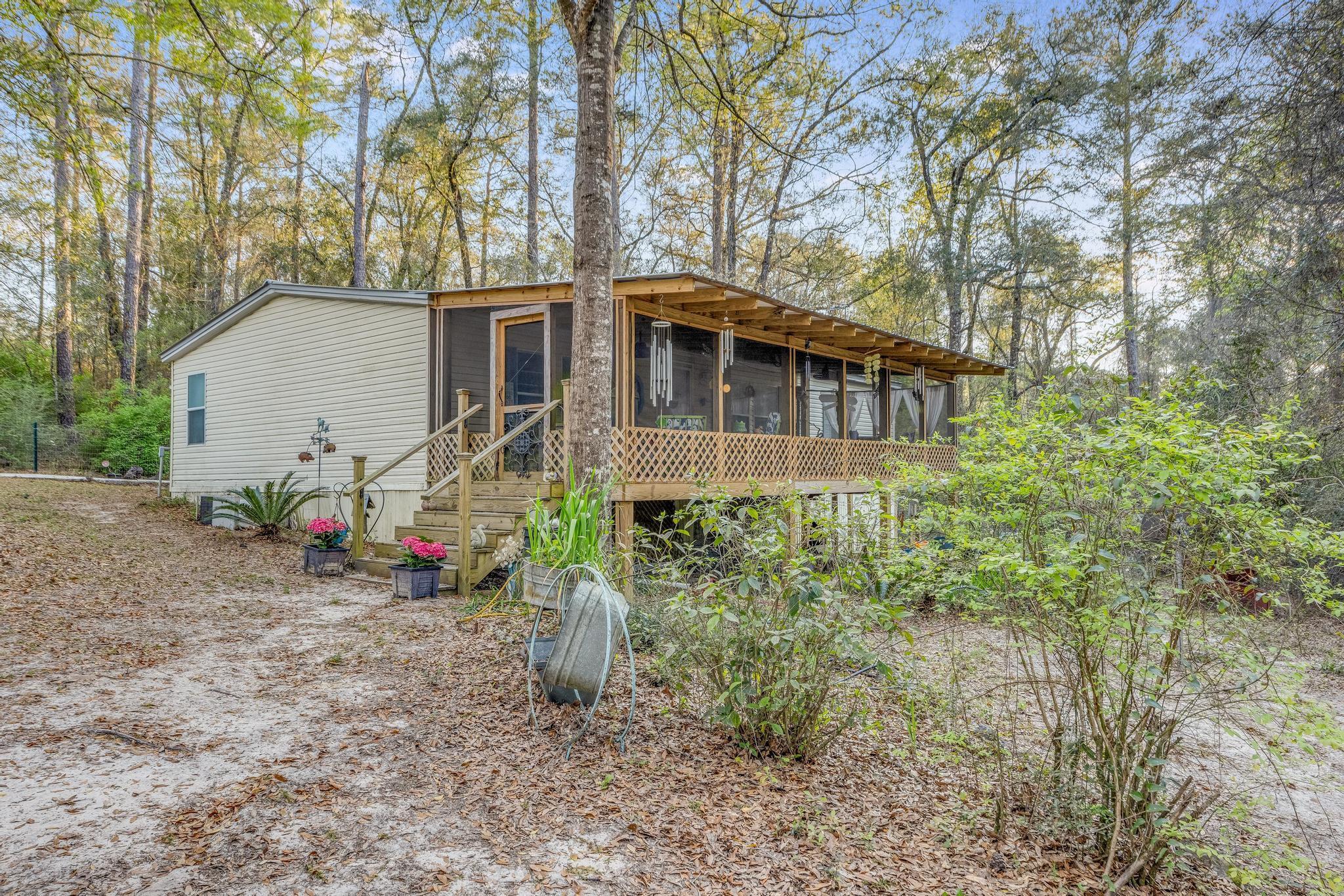 5084 Richardson Road Crestview, FL 32539 - Photo 13 of 24 a front view of a house with garden