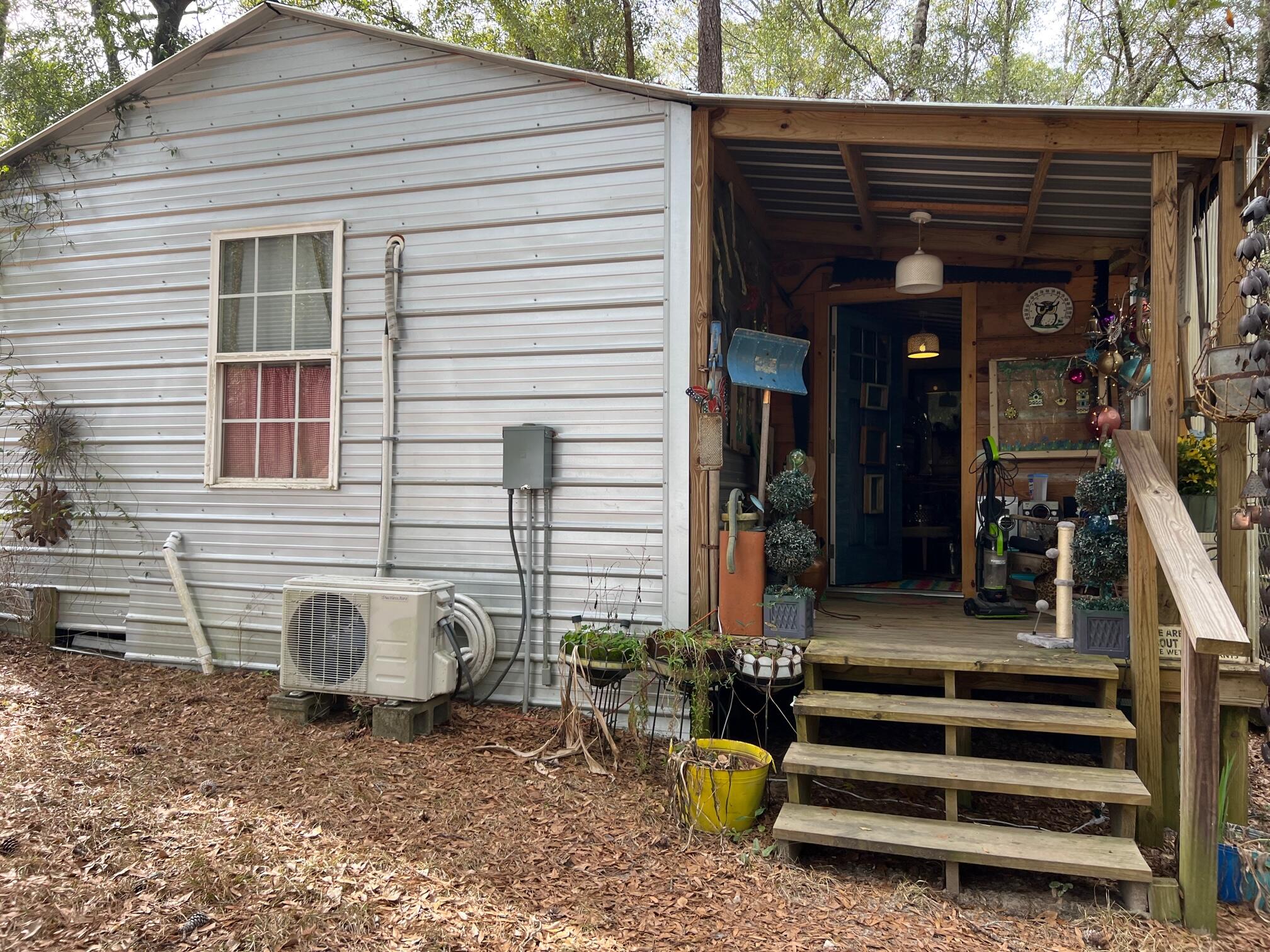 5084 Richardson Road Crestview, FL 32539 - Photo 16 of 24 a view of a house with a patio and a yard