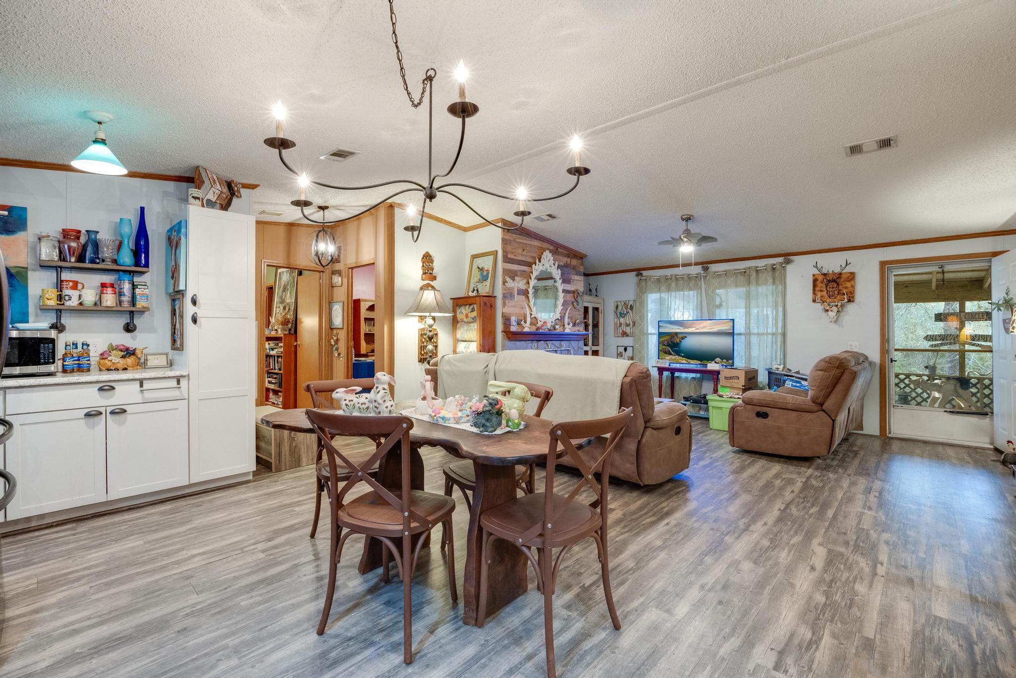 5084 Richardson Road Crestview, FL 32539 - Photo 4 of 24 a view of a dining area with furniture and wooden floor