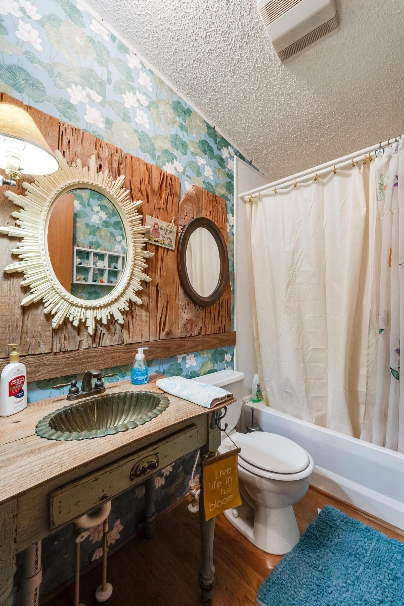 5084 Richardson Road Crestview, FL 32539 - Photo 6 of 24 a bathroom with a toilet a sink and a mirror