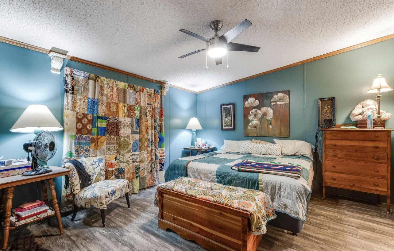 5084 Richardson Road Crestview, FL 32539 - Photo 7 of 24 a bedroom with a bed and wooden floor