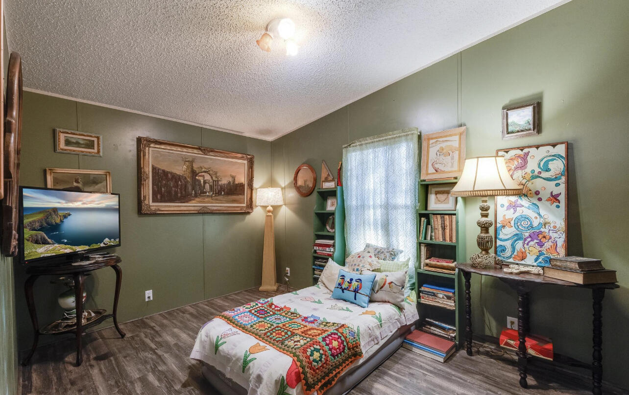 5084 Richardson Road Crestview, FL 32539 - Photo 9 of 24 a bedroom with a bed table storage and utility