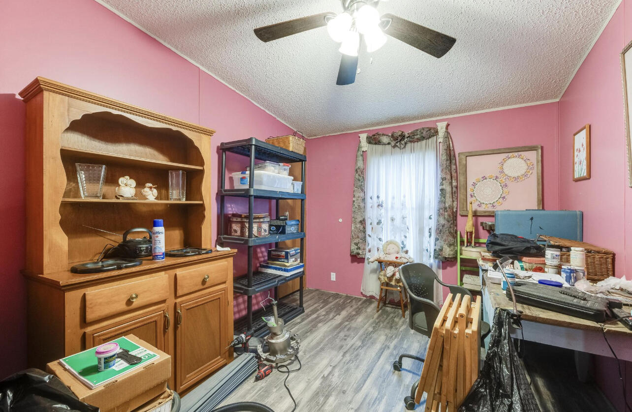 5084 Richardson Road Crestview, FL 32539 - Photo 10 of 24 a living room with furniture a bookshelf and a bookshelf