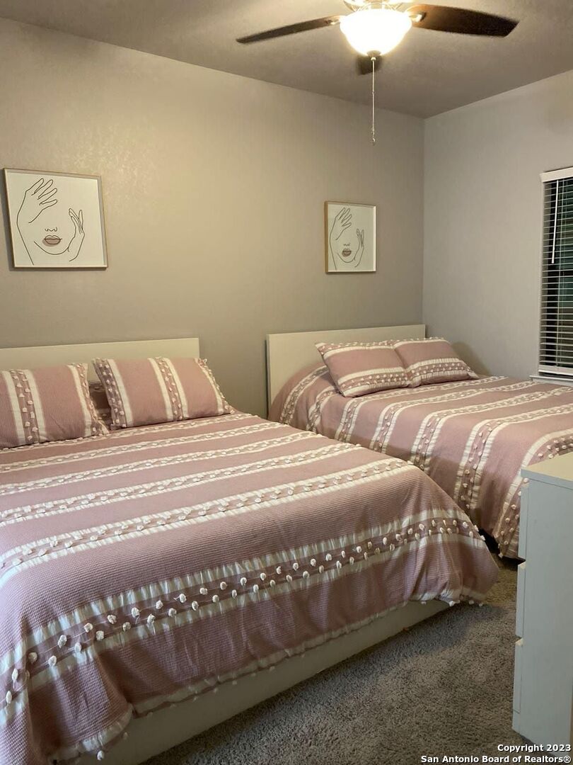 6160 Eckhert Road, Unit 1406 San Antonio, TX 78240 - Photo 11 of 14 a bedroom with a bed and window