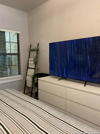 a bathroom with a toilet and a shower curtain