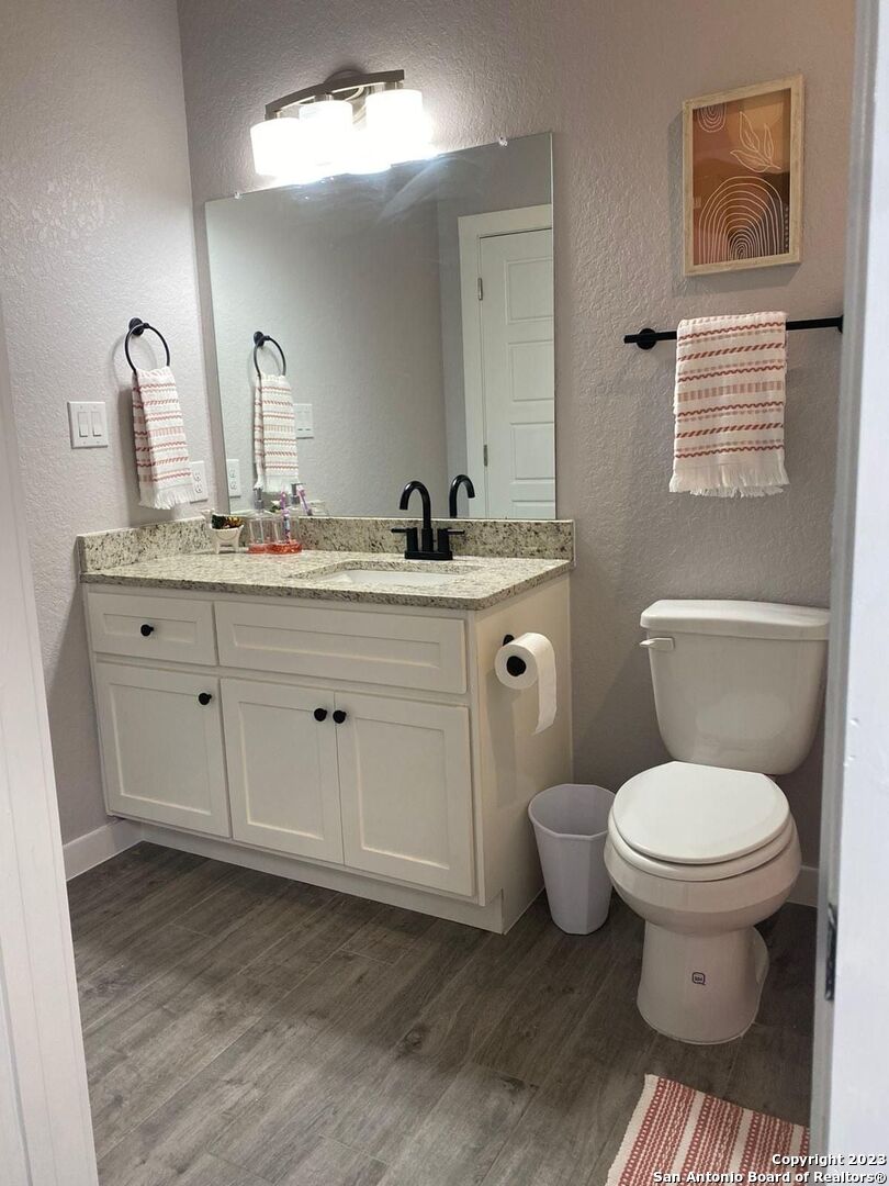 6160 Eckhert Road, Unit 1406 San Antonio, TX 78240 - Photo 14 of 14 a bathroom with a toilet sink and mirror