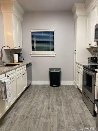 a kitchen with a sink and a stove
