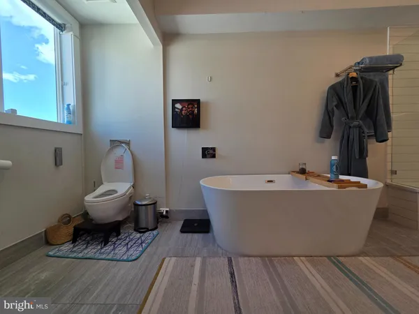 a white bath tub sitting next to a toilet