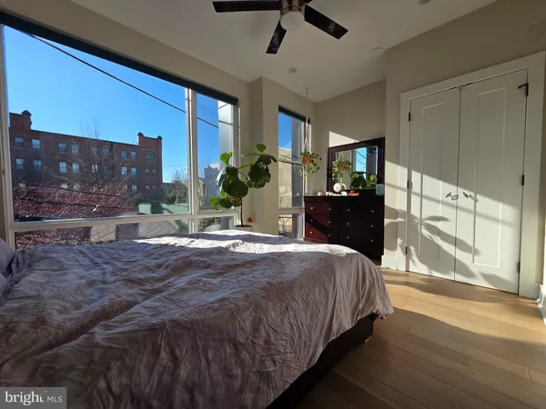a spacious bedroom with a bed and a dresser