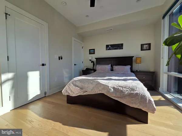 a bedroom with a bed and painting on the wall